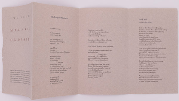 Broadside is fully open so you can see the cover on the far left panel, the first poem on the two middle panels, and the second poem called Birch Bark on the far right panel. Blue, brown, and black text on grey handmade paper.