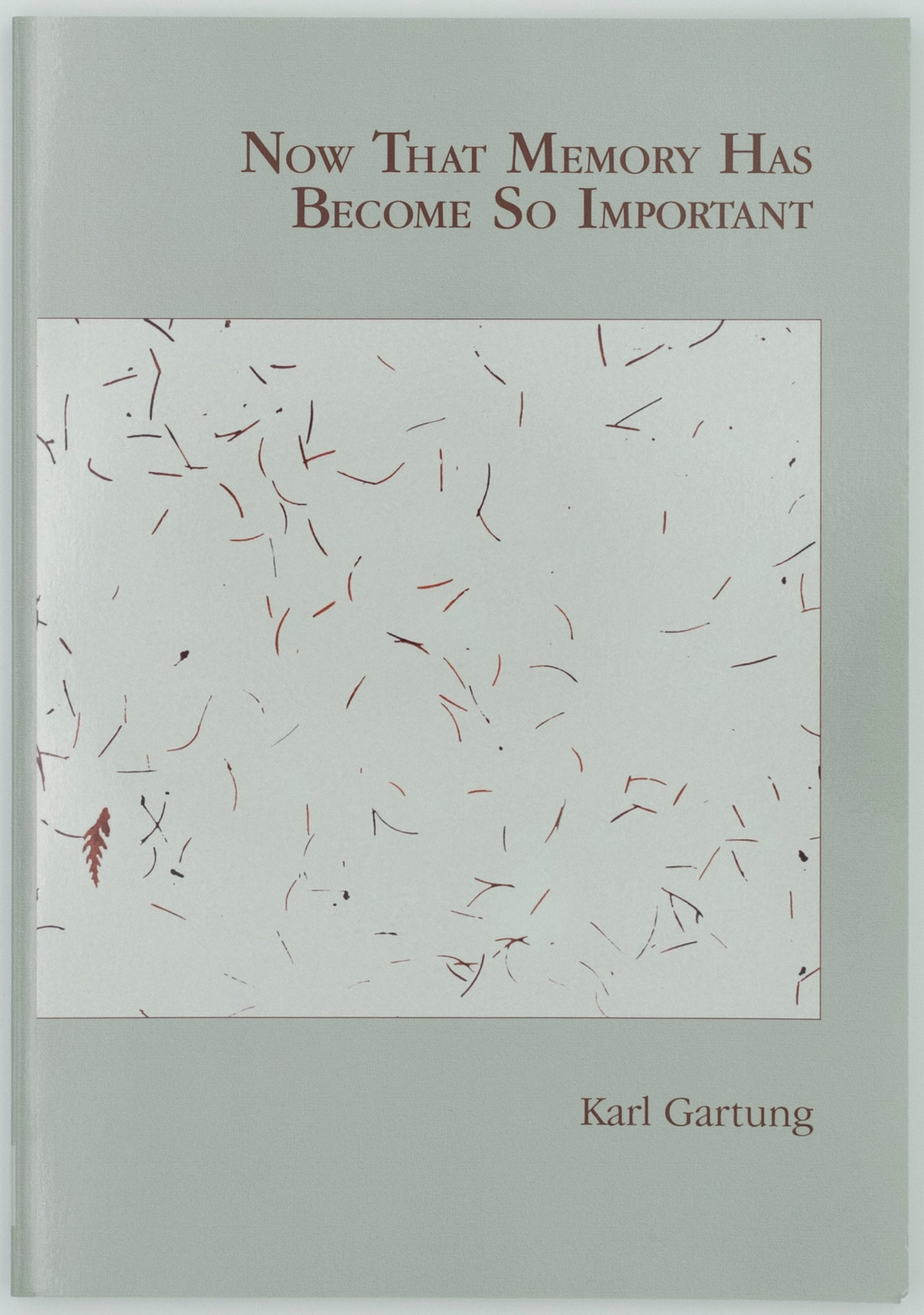 Cover of book titled now that memory has become so important by Karl Gartung. The book is a light green with brown text. There is a lighter green square in the center with brown lines scattered everywhere.