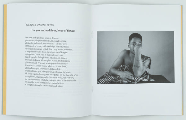 On the right page there is a black and white photo of a black male presenting individual leaning their body on a pile of bullets that are on a table with more bullets draped over their shoulder. On the left page there is a poem by Reginald Dwayne Betts called For you: anthophilous, lover of flowers in black text on a white background.