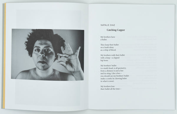 On the left page there is a black and white photograph. It is a close up of a black female presenting individual holding a bullet in their left hand and mouth. The right page has a poem by Natalie Diaz called Catching Copper in black text on a white background.