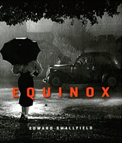 The cover of a book titled Equinox by Edward Smallfield. The title Equinox is in large orange letters in the middle of the page. The cover is a black and white photograph of a female presenting individual standing with an umbrella  in the rain facing a car that is parked across the street. On the side that the individual is standing on they are surrounded by trees and they have their back to us. On the side with the car there is a individual looking across the street at the main figure on this cover.